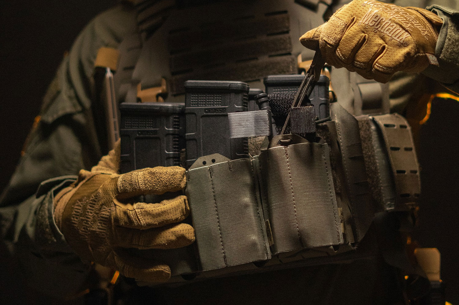 Soldier adjusting his ammunition pouches on his chest